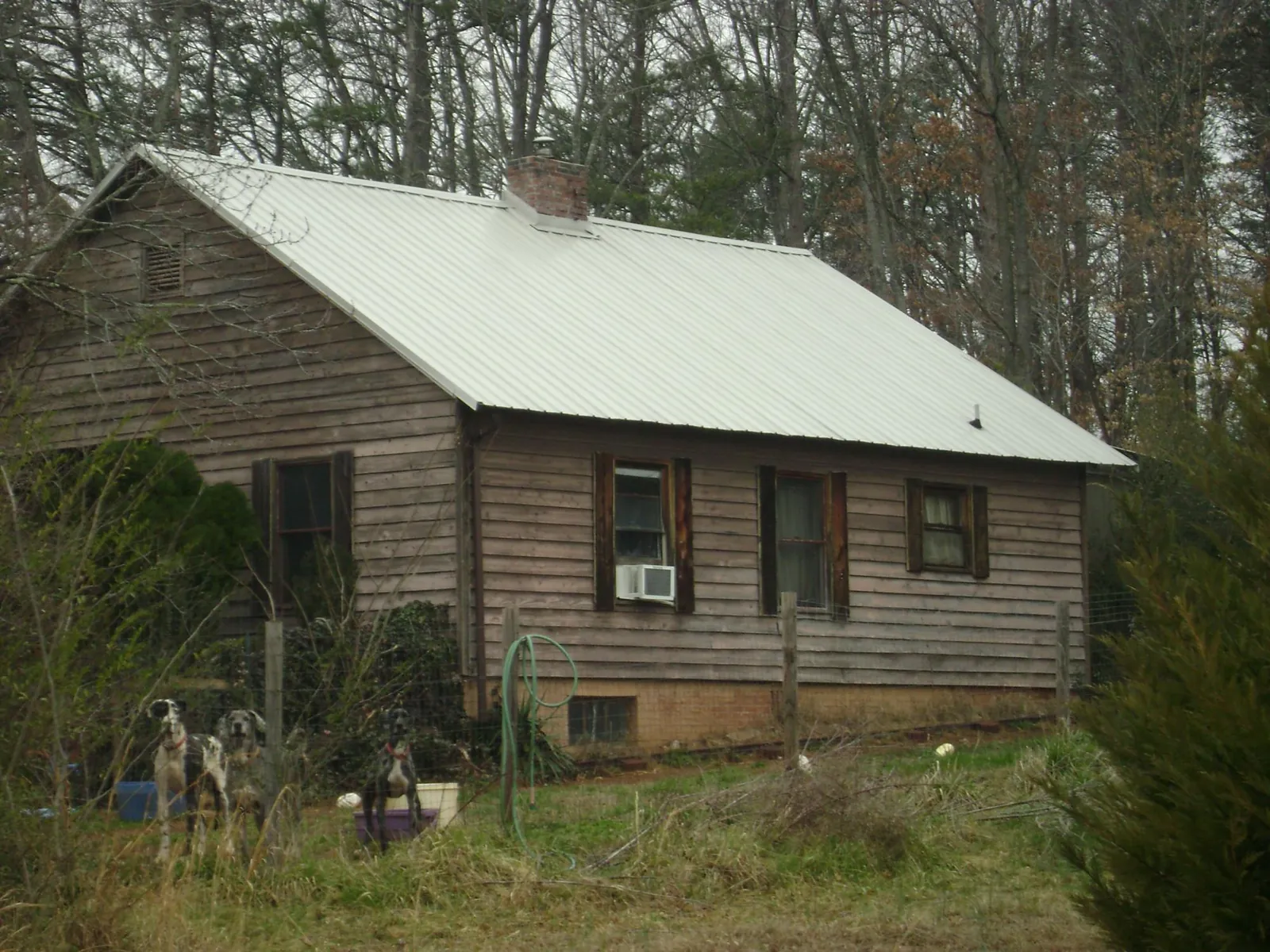 White metal roof on an old wood sided farmhouse, from a Metal Roof Installation job in Kenesaw